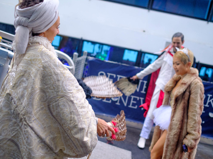 As attendees walked on the gangplank, volunteers Erika Brown and Daniel Michael cleared away negative energy with smudging sage sticks. Brown kept telling partygoers to "slow down" so she could brush more of the smoke their way.