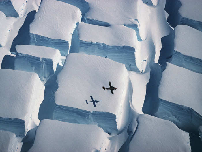 This photo of a Twin Otter airplane flying over a crevassing ice sheet in Southern Antarctica was shot in 1995 and is now scanned into the British Antarctic Survey.