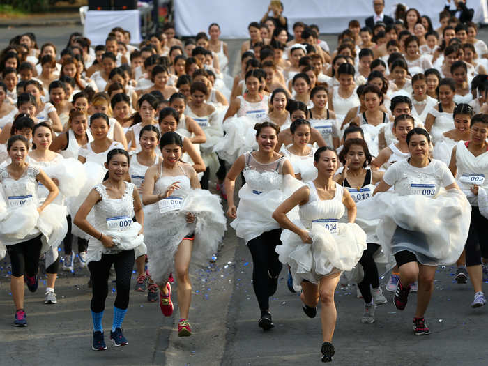 Brides-to-be participate in the "Running of the Brides" race in a park in Bangkok, Thailand.