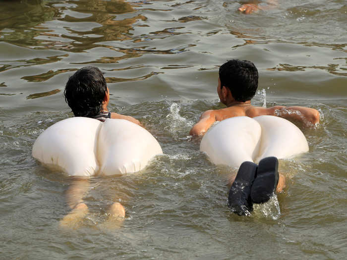 Boys swim in a stream during a heatwave in Islamabad, Pakistan.