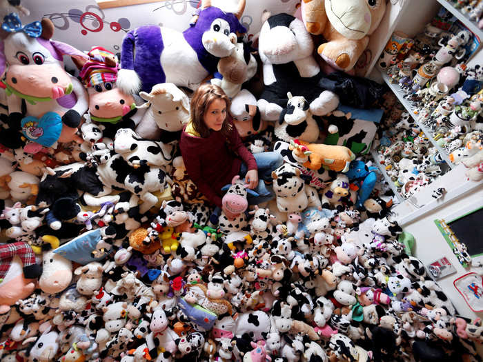 French model Emeline Duhautoy poses with her collection of 1,679 stuffed toy cows she has been collecting for over seven years at her home in Saint-Omer, northern France.