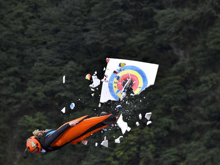 A wingsuit flyer hits the target during the Wingsuit Flying World Championship in Zhangjiajie, Hunan province, China.