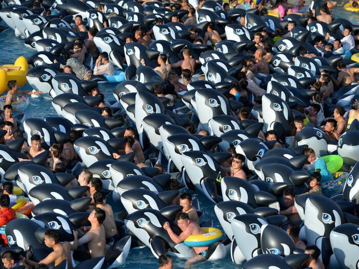 People cool off at a water park on a hot day in Fushun, Liaoning province, China.