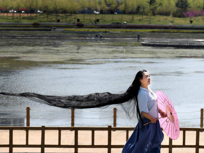 A woman with long hair poses for pictures in Weihai, Shandong province, China.