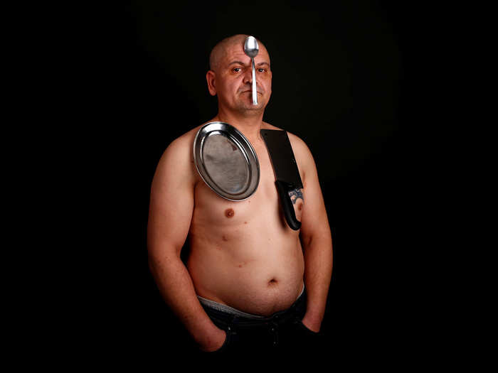 Nermin Halilagic poses with kitchen utensils in Bihac, Bosnia. Halilagic discovered earlier this year that he had the unusual ability to attach items to his body using what he says is a special energy radiated from his body. Without making any special preparation, he says he is able to hold on to spoons, forks, knives, and other kitchen appliances, as well as non-metal objects like remote controls, all plastic stuff, and cell phones.