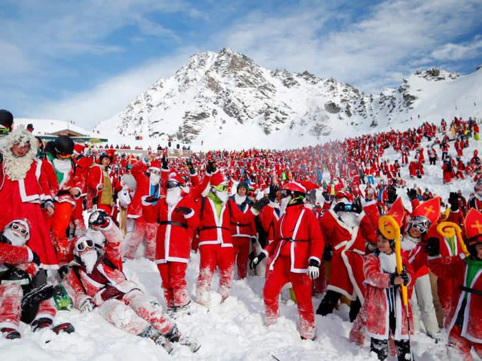 People dressed as Santa Claus enjoy the snow during the Saint Nicholas Day at the Alpine ski resort of Verbier, Switzerland.