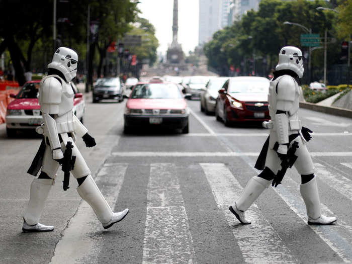 Two people dressed as Star Wars Storm Troopers cross Reforma Avenue in Mexico City, Mexico.