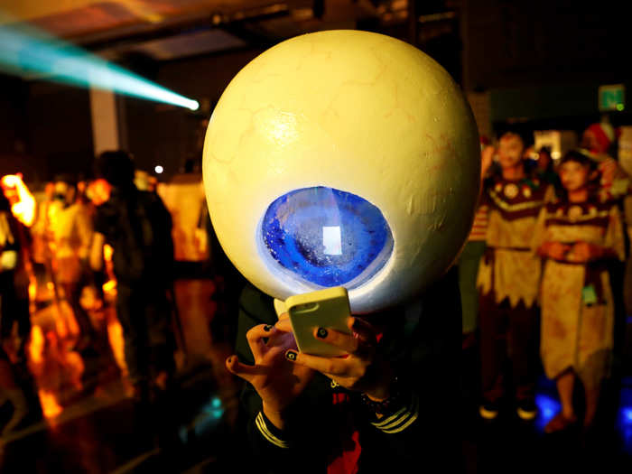 A participant in costume uses a mobile phone at a Halloween event in Kawasaki, south of Tokyo, Japan.