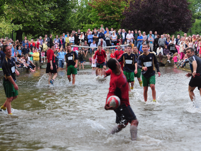 Bourghton-on-the-Water hosts a football match on the August Bank Holiday Monday, every year. Here, the Bourghton Rovers first team (in red) take on the reserves in the River Windrush. As you can see, it attracts quite a crowd.