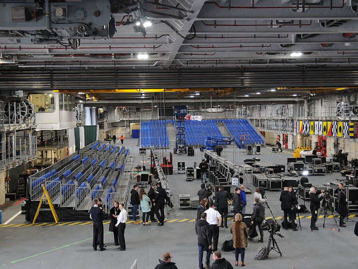 The hangar is on top of the magazine, a huge compartment of the carrier full of bombs and other munitions which can be automatically brought into the hangar to "weaponise" (load up) the aircraft.