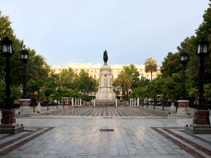 Drink and sing with Spanish locals in Plaza Nueva, Seville.