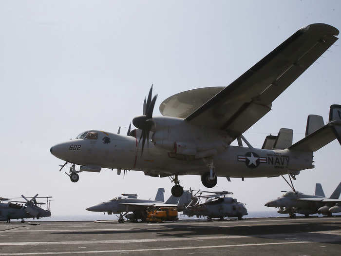 A US Navy Hawkeye surveillance plane lands on the USS Carl Vinson following a patrol off the disputed South China Sea on March 3.