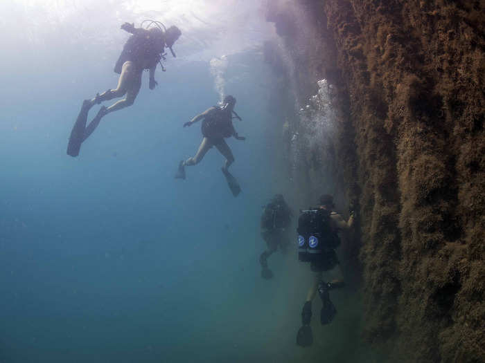 Sailors assigned to Underwater Construction Team 2 conduct a pier inspection in Apra Harbor, Guam on June 13.