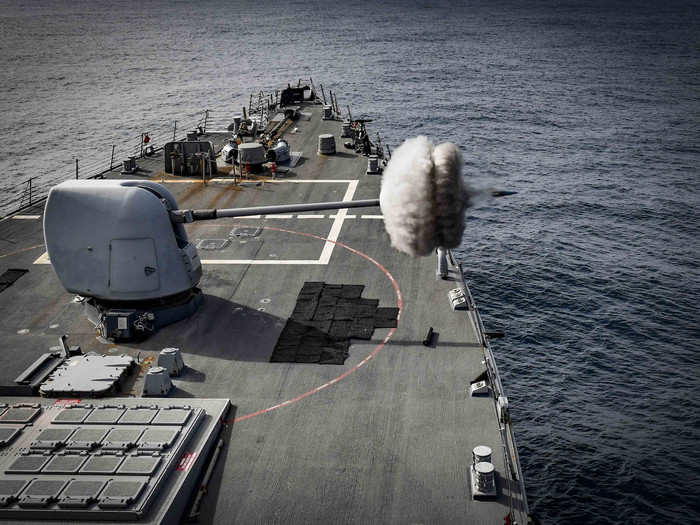 The USS Oscar Austin fires its Mark 45 5-inch gun during a live-fire exercise in the Arctic Circle on September 12.