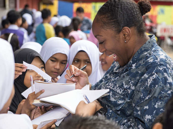 A sailor interacts with students during a community engagement event at Lumut Naval Base in Malaysia on September 20.