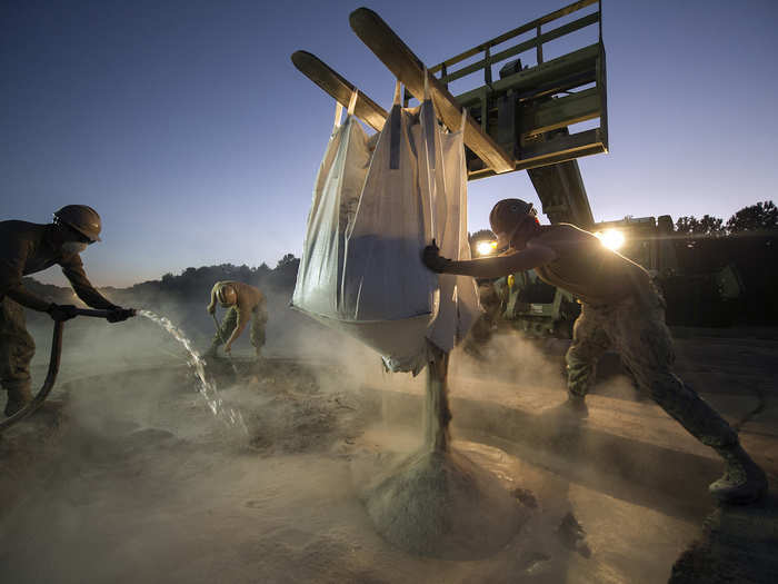 Seabees fill a crater using a ‘Super Sack’ during a rapid airfield damage repair exercise on October 17.