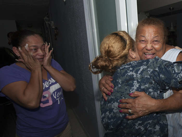 A sailor assigned to the USS Wasp reunites with her grandma (right) and her aunt during a family assessment in Puerto Rico on October 25 in the aftermath of Hurricane Maria.