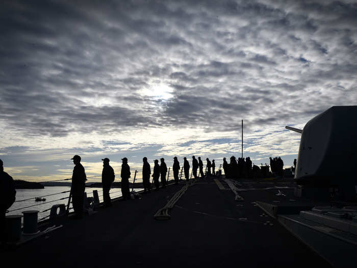 Sailors man the rails of the USS Oscar Austin as the ship departs Oslo, Norway, following a port visit on October 31.