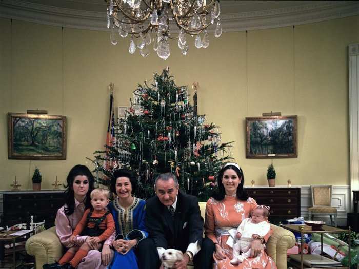 Here, the Johnson family poses in front of a Christmas tree in the Yellow Oval Room.