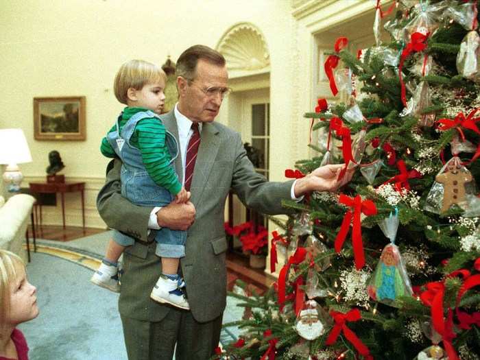 Christmas during the first Bush administration was a family affair. Here, George H.W. Bush shows his grandchildren the Oval Office Christmas tree.