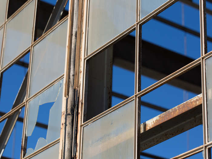 Sunlight streams through broken windows.