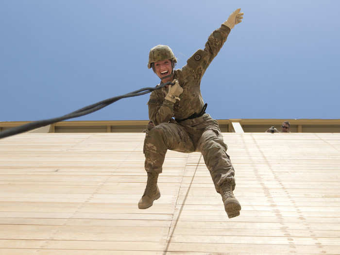 A US Army reserve soldier rappels off of a tower during professional development training at Camp Buehring in Kuwait on July 31.