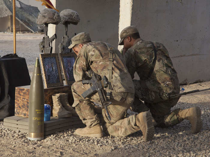 Paratroopers deployed in support of Operation Inherent Resolve kneel during a memorial service honoring two fallen Paratroopers in northern Iraq on August 17.