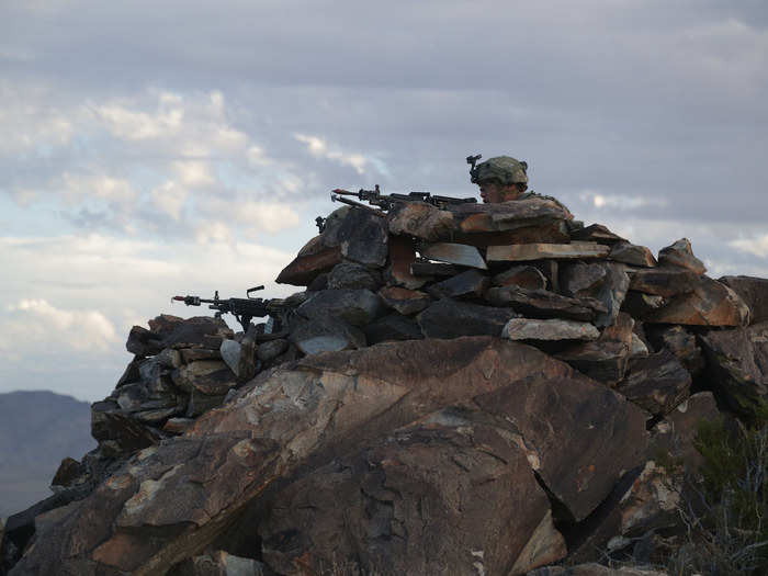 Soldiers secure an objective on top of a mountain during Decisive Action Rotation 17-08 at Fort Irwin on August 21.