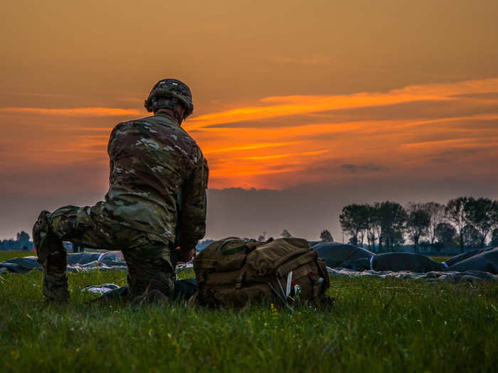 A paratrooper from the 173rd Airborne brigade collects his parachute after landing on September 26.