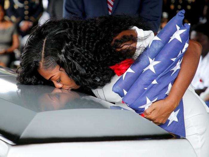 Myeshia Johnson, wife of US Army Sergeant La David Johnson, who was among four special forces soldiers killed in Niger, kisses his coffin at a graveside service in in Florida on October 21.