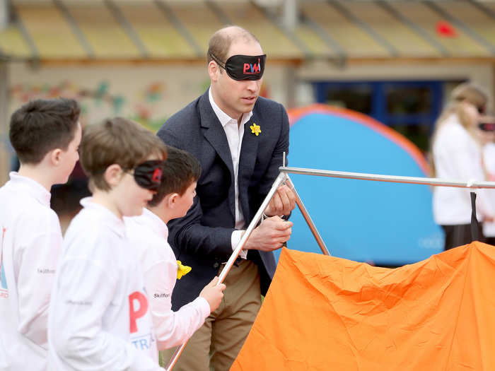 Prince William had more fun and games trying to put up a tent blindfolded in Abergevenny, Wales, while launching a children