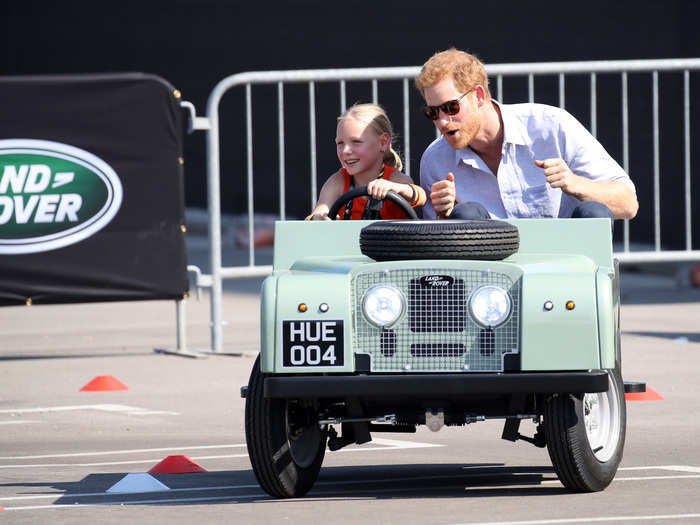 Harry also took a moment to enjoy a spin in a tiny Land Rover, driven by five-year-old Daisy Gommers, during the games.