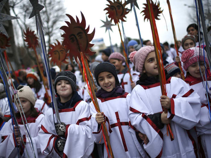 During the Orthodox Christmas, clergy members lead a procession through the streets of Tbilisi, Georgia, where participants give gifts and sweets to children and the needy.