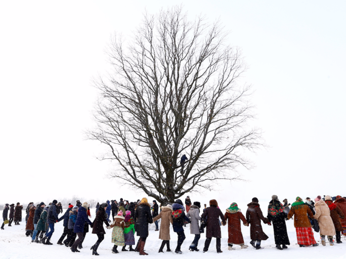 People in the village of Martsiyanauka, Belarus, gather around a tree to mark the end of an ancient pagan holiday known as Kolyada. The rituals are believed to bring a good harvest.