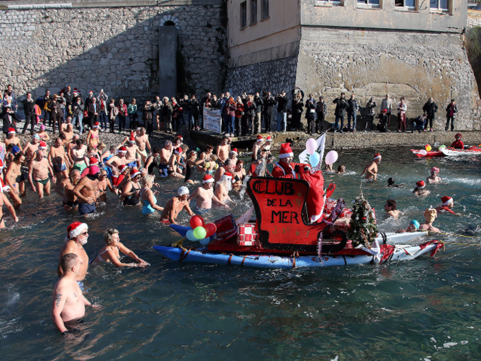 In Nice, France, brave souls wearing Santa Claus caps take a dip in the freezing cold riverbank. The tradition has gone on for over 70 years.