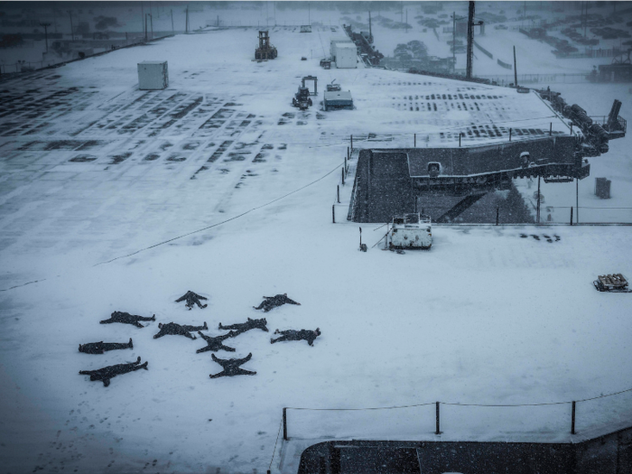 Sailors create snow angels on the flight deck of the aircraft carrier USS Dwight D. Eisenhower on January 7 after returning home from a deployment.