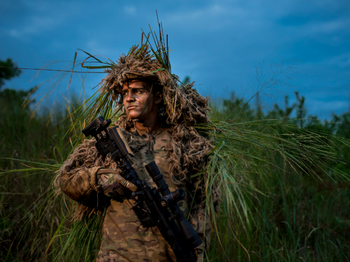 A US Army Reserve sniper and infantry soldier poses at Joint Base McGuire-Dix-Lakehurst in New Jersey on July 26.