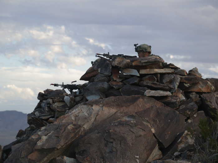 Soldiers secure an objective on top of a mountain during Decisive Action Rotation 17-08 at Fort Irwin on August 21.