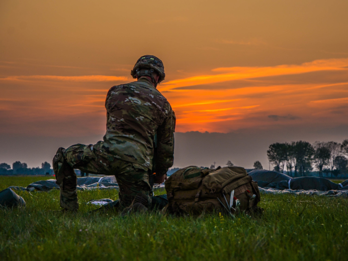 A paratrooper from the 173rd Airborne brigade collects his parachute after landing on September 26.