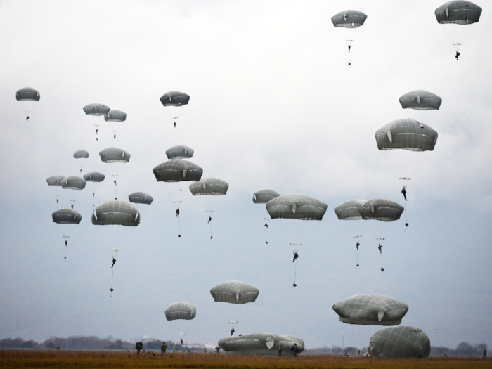 US Army paratroopers conduct an airborne operation from a C-130 Hercules in Pordenone, Italy, on December 12.