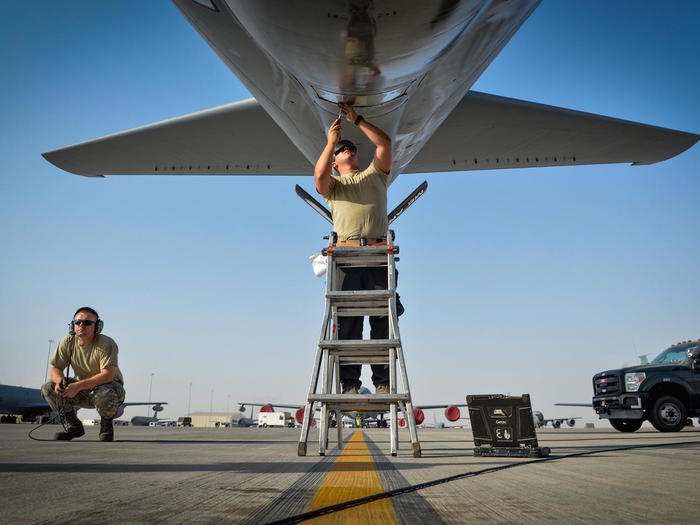 A 340th Aircraft Maintenance Unit maintainer adjusts the window of a KC-135 Stratotanker boom pod before a flight in support of Operation Inherent Resolve, at Al Udeid Air Base, Qatar on July 3.