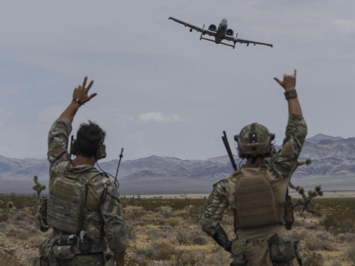 Joint terminal attack controllers wave at an A-10 Thunderbolt II attack aircraft during a show of force on the Nevada Test and Training Range on July 19.