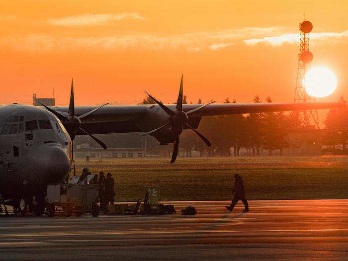 A crew chief assigned to the 374th Aircraft Maintenance Squadron walks on the flight line near a C-130J Super Hercules during Exercise Beverly Morning 17-06 at Yokota Air Base, Japan on October 26.