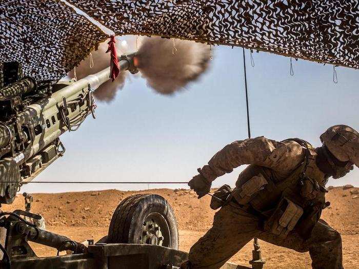 A Marine with the 11th Marine Expeditionary Unit fires an M777 howitzer during a fire mission in northern Syria as part of Combined Joint Task Force Operation Inherent Resolve on March 24.