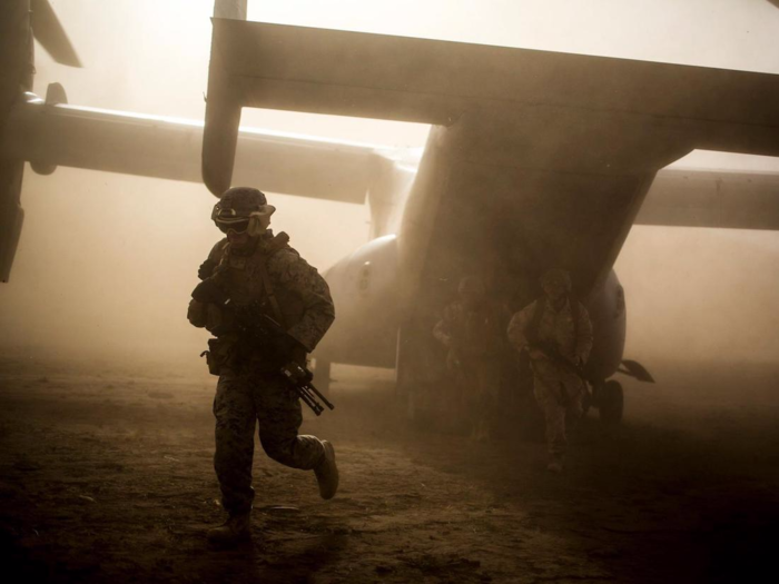 Marines assigned to Special Purpose Marine Air-Ground Task Force-Crisis Response Africa exit an MV-22B Osprey during assault training at Sierra Del Retin, Spain, on June 26.