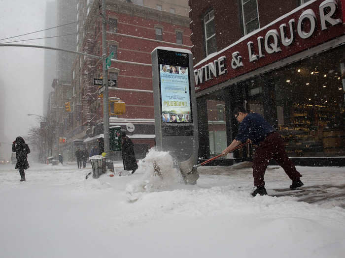 Just a few pedestrians and people shoveling snow.