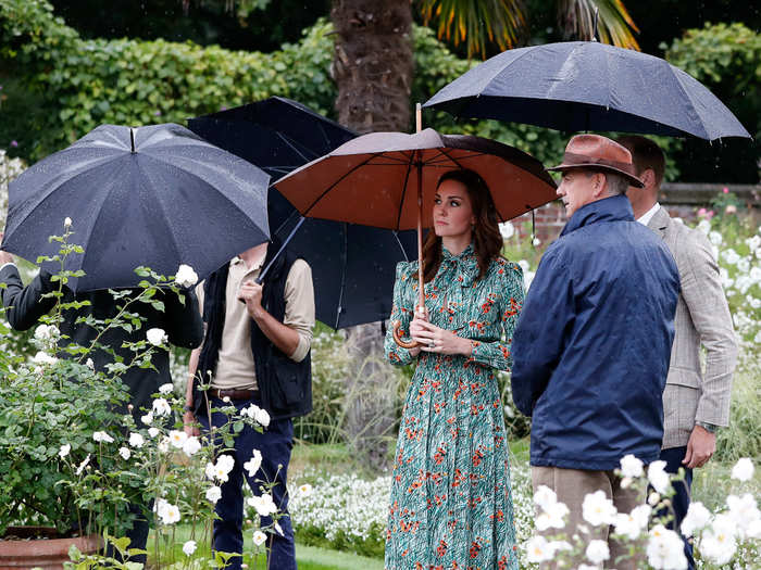 She wore a green, printed Prada dress with this $2,340 outfit to the Diana Memorial Garden.