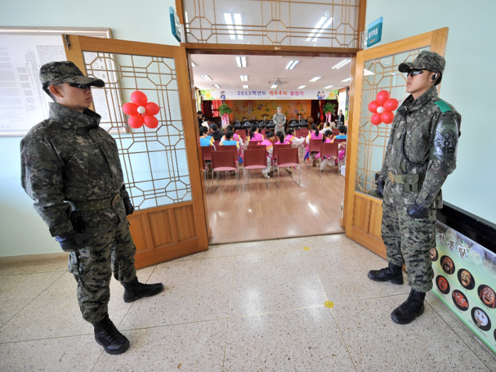 While students study under a heavy military presence.