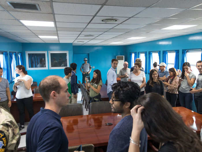 Groups of tourists are allowed into the heavily guarded conference rooms which sit across the Korean border, allowing people to technically enter North Korea.