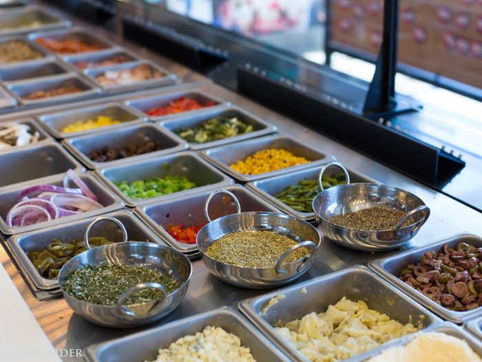 The chain draws inspiration from fast-casual king Chipotle with its assembly line. Customers can choose from a selection of toppings in front of them.